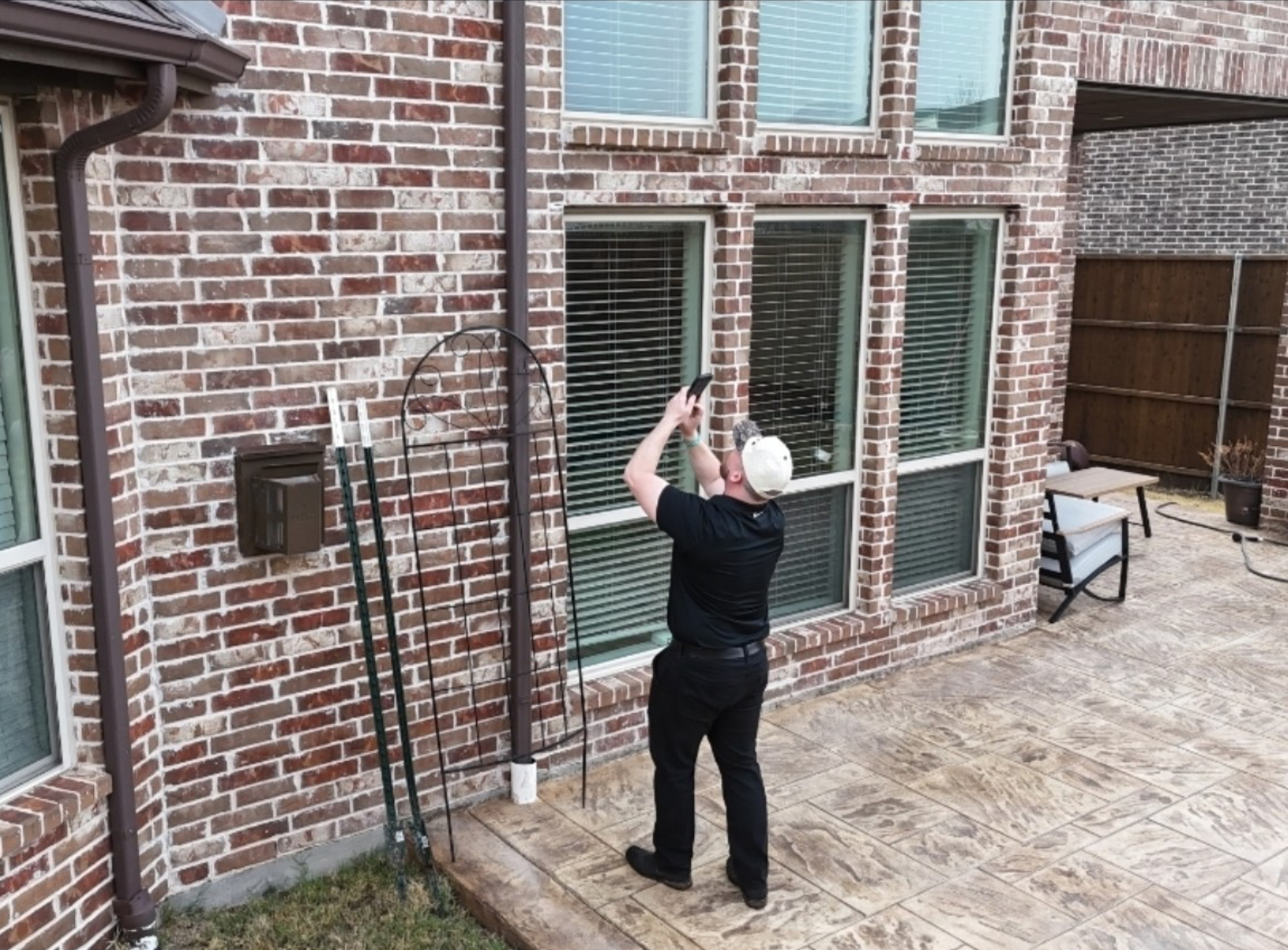 Team member documenting roof and property during inspection